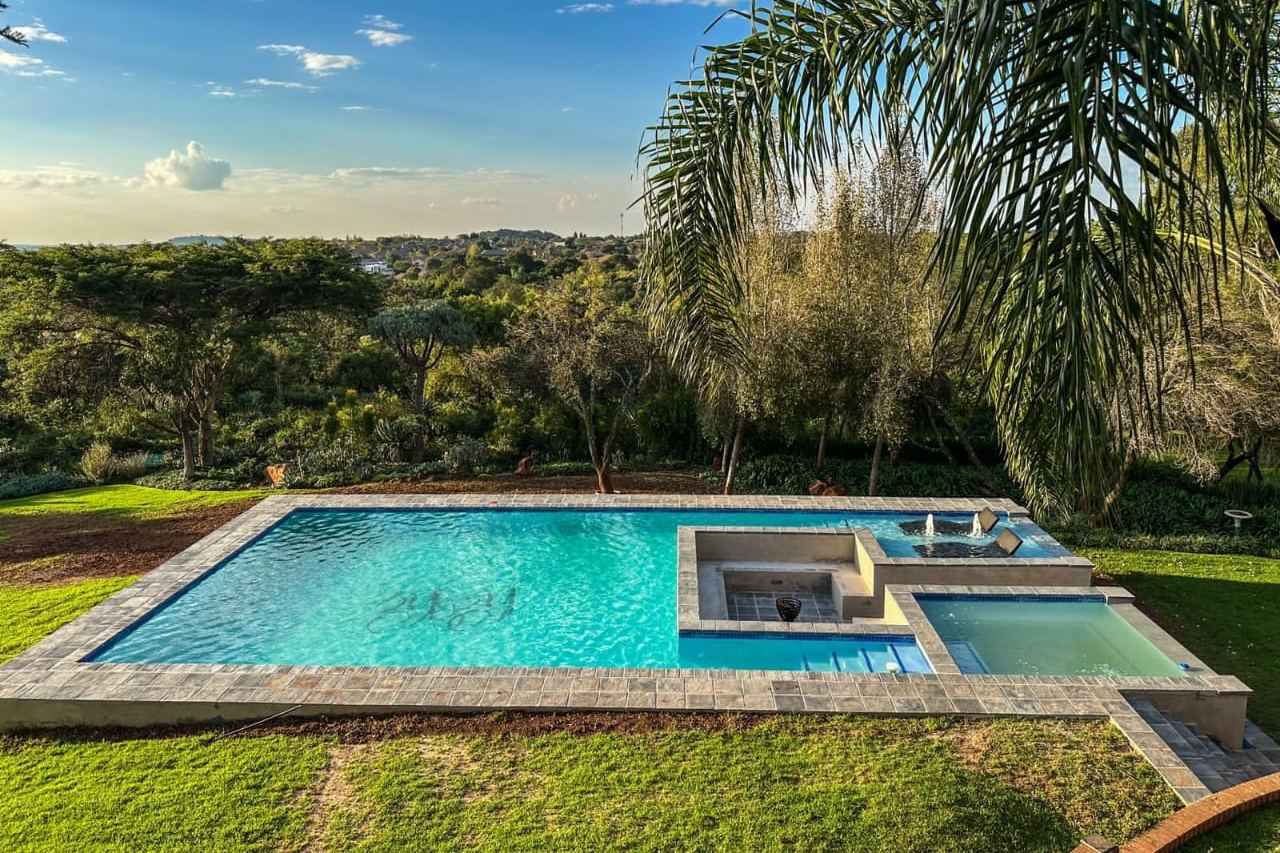 Pool with spa and water features overlooking a valley